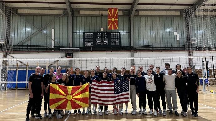 the 赌博娱乐平台网址大全 delegation and North Macedonian host representatives posed for a photo in a gym, holding up a USA flag and a North Macedonian flag