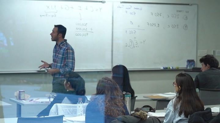 Professor teaches to a full classroom