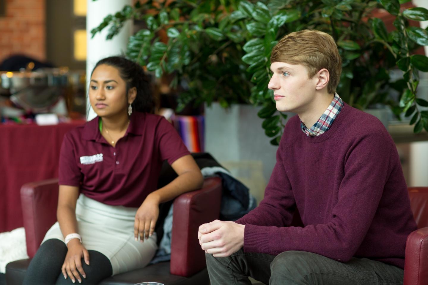 Nick Santulli and Amulya Deva sit in chairs in the Coates Student Center