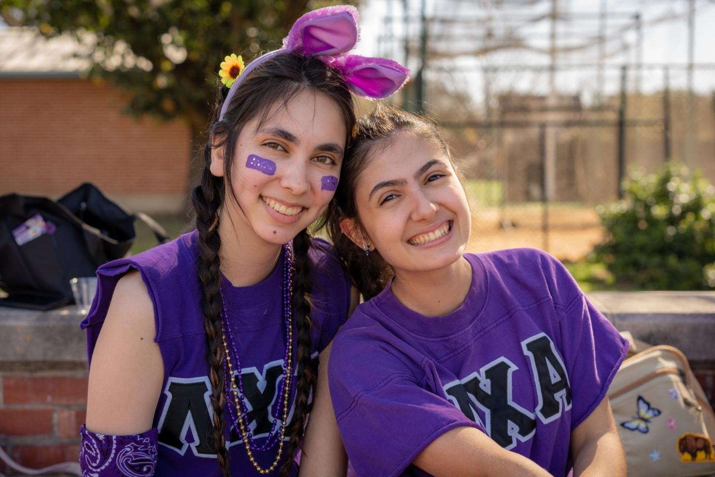 photo of two students wearing sorority letter shirts and smiling