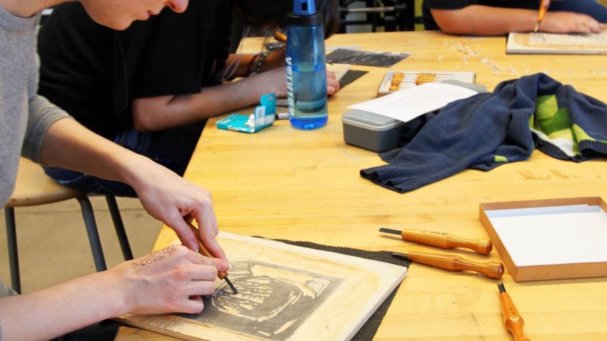 Students working at a table drawing