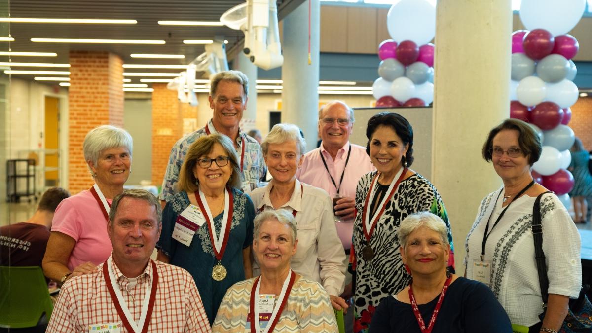 photo of a group of alumni smiling at an Alumni Weekend event